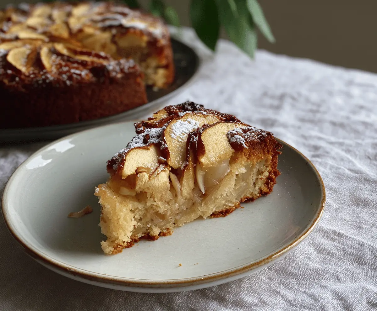 Delicious flourless apple, almond, and cardamom cake with fresh apple slices and almond slivers on top, served on a rustic plate