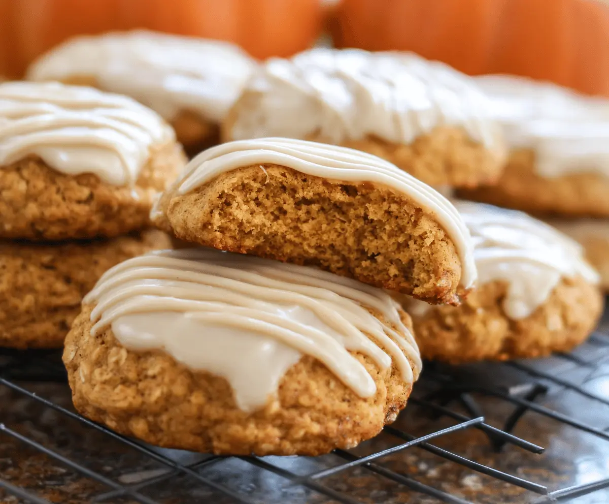 Homemade pumpkin oatmeal cookies topped with cinnamon sugar icing on a rustic plate, perfect for fall treats
