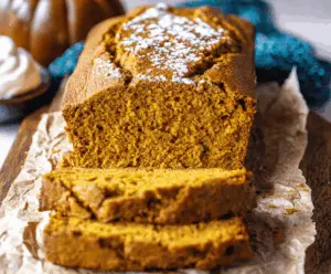 Creamy vanilla pudding layered with spiced pumpkin bread, topped with whipped cream and cinnamon for a delicious fall dessert.