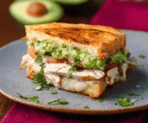 Delicious Chicken Avocado Melt Sandwich with melted cheese and fresh ingredients.