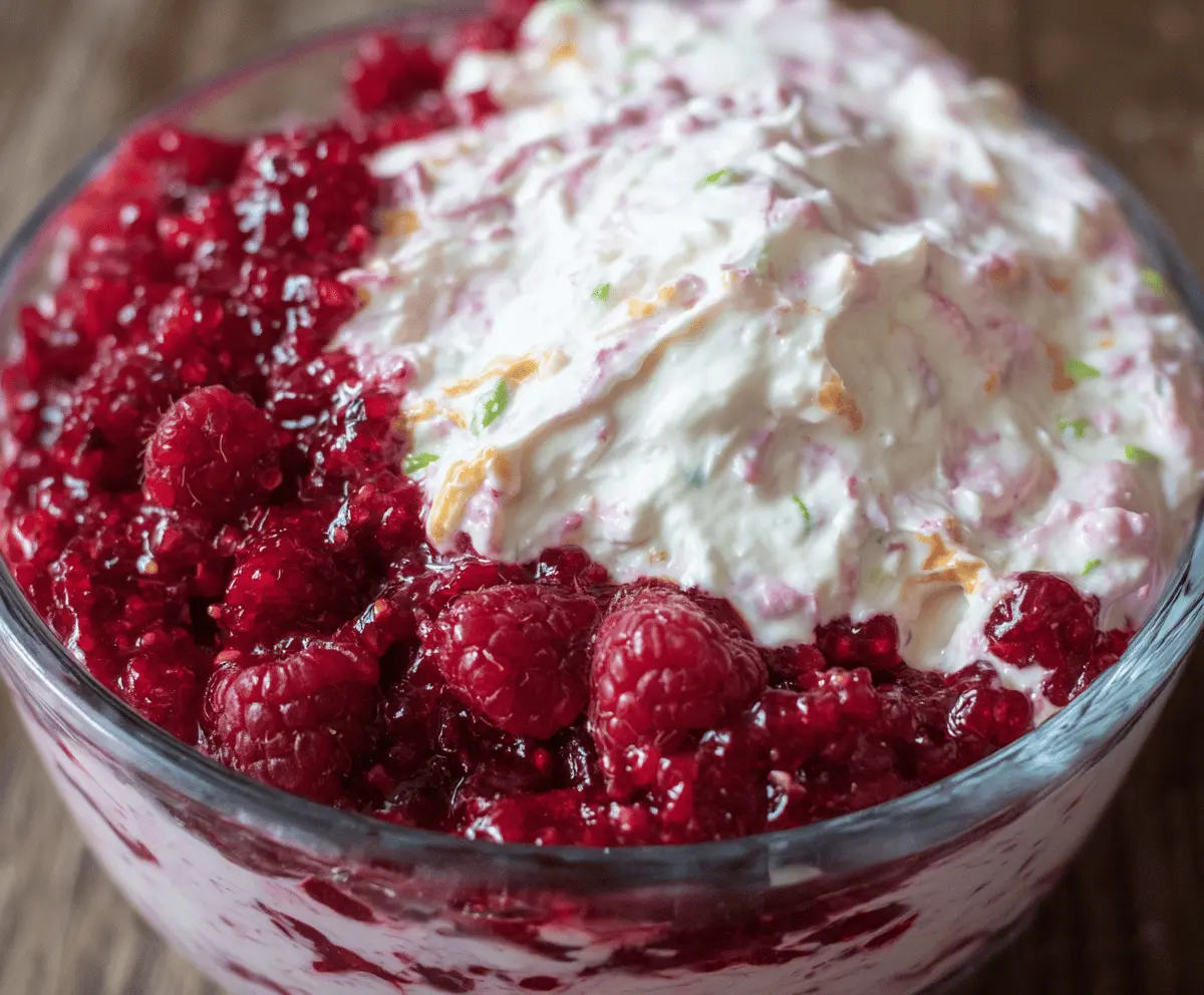 Delicious raspberry dip served in a bowl with fresh raspberries and a spoon, perfect for dipping fruits and snacks