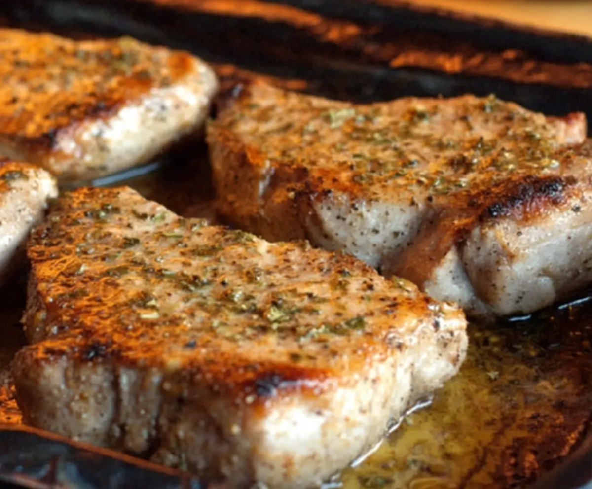 Oven Baked Ranch Pork Chops served with fresh vegetables on a plate.