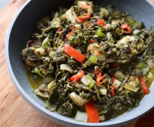 Delicious callaloo and saltfish dish served with fresh vegetables and traditional Caribbean spices.