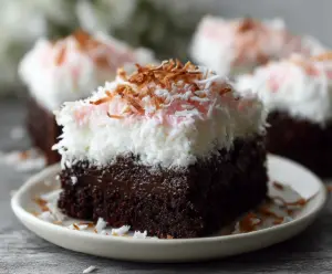 Delicious Easy Sno Ball Brownies topped with marshmallow and coconut for a sweet treat.